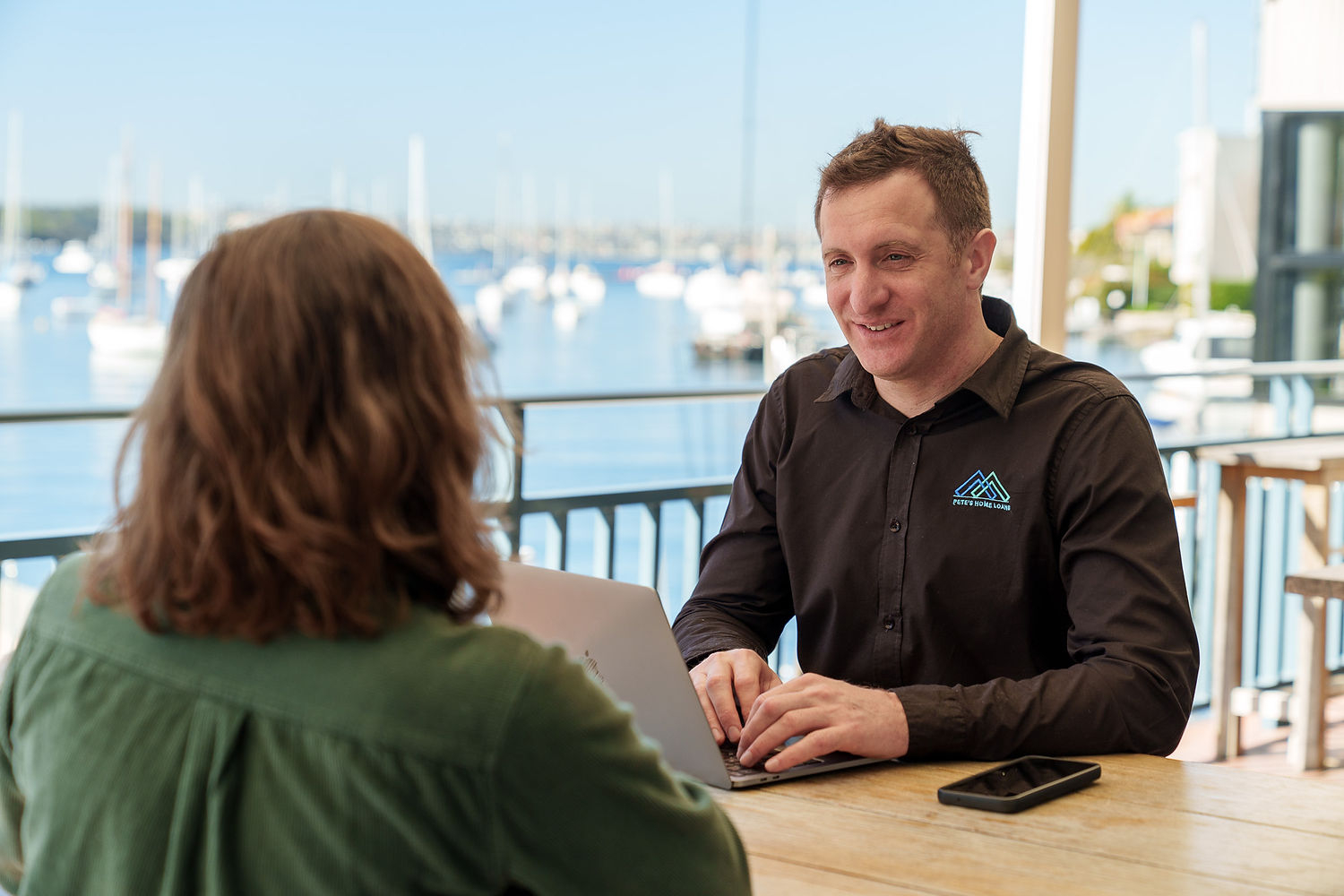 Pete meeting with a home loan client by Sydney Harbour